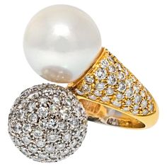 Vintage Bypass Pave Diamond & South Sea White Pearl Gold Ring. Vintage Bypass Diamond and South Sea Button White Pearl Ring is set in gold mounting. The Bypass design features a Pave set Diamond Ball with 4.50 cts. of Round Brilliant and South Sea White Pearl measuring at 12mm. Celebratory and chic, this Vintage piece from the 1960s symbolizes the decade as the height of mod fashion. CARAT WEIGHT: 4.50cts (approx.) SIZE: 7.5 MATERIAL: 18K GOLD WEIGHT: 13.6gr Fancy Pink Diamond Ring, Diamond And Pearl Ring, Cocktail Ring Designs, Pearl Cocktail Ring, White Pearl Ring, Milano Italy, Pearl And Diamond Ring, Gold Cocktail Ring, Diamond Settings