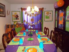 a dining room table is set with plates and place settings for the children's birthday party