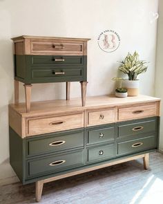 an old dresser has been painted green and is next to a potted plant