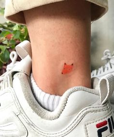 a person with a small tattoo on their ankle