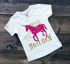 Be your own unicorn, make your own magic! This whimsical and inspiring tee is perfect for the princess in your life. Unicorn Clothes, Unicorn Shirts, White Short Sleeve Tops, Unicorn Girl, Unicorn Shirt, Cat Graphic Tee, Glitter Print, Vinyl Shirts, Inspirational Shirt