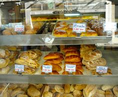 a display case filled with lots of different types of doughnuts and pastries