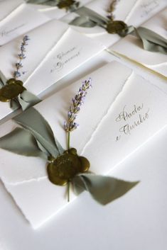 the wedding stationery is laid out on top of each other with ribbons and flowers