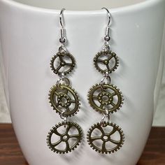 Triple Bronze Steampunk Earrings With Clock Gears 925 Sterling Silver Plated Hooks Center Wheel Has Nice Rim Detail - Etsy Steampunk Nickel-free Brass Earrings, Steampunk Brass Nickel-free Earrings, Nickel Free Brass Steampunk Earrings, Steampunk Dangle Earrings For Pierced Ears, Steampunk Style Dangle Jewelry, Steampunk Brass Jewelry For Pierced Ears, Nickel Free Metal Steampunk Earrings, Steampunk Silver Metal Earrings, Steampunk Style Silver Metal Earrings