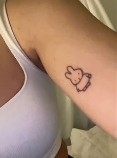 a woman's arm with a small elephant tattoo on the left side of her right arm