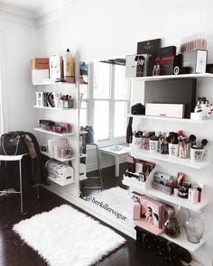 a room with white shelving and shelves filled with personal items