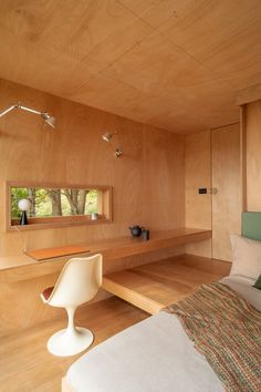 a bedroom with wood paneling and white furniture