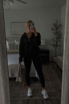 a woman taking a selfie in the mirror with her cell phone and shoes on