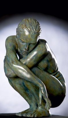 a bronze statue of a man crouching down with his hands on his knees and eyes closed