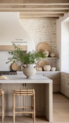 a kitchen with two stools next to a stove top oven and an island in the middle