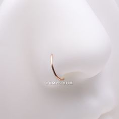 a close up of a gold ring on a white mannequin's head