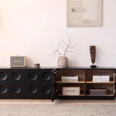 a black entertainment center with speakers on it