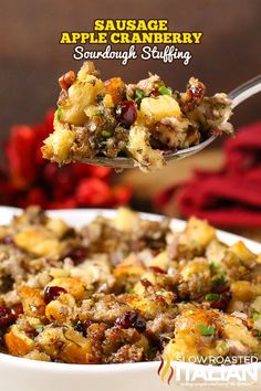 sausage, cranberry and apple stuffing in a white bowl with a serving spoon