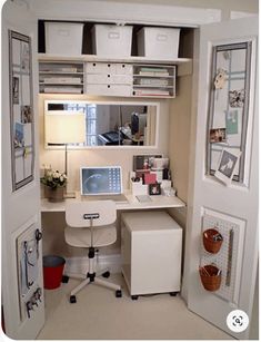 an open closet with a desk and computer on it