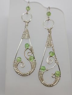 Silver artistic wire wrapped with green glass beads Hand Wrapped Wire Dangle Earrings, Bohemian Wire Wrapped Earrings, Silver Wire Wrapped Earrings, Hand Wrapped Green Earrings For Gifts, Green Hand Wrapped Earrings As Gift, Green Hand Wrapped Earrings For Gift, Silver Plated Wire Wrapped Wrap Earrings As Gift, Wire Wrapped Silver Plated Drop Earrings, Sterling Silver Dangle Earrings With Wire Wrapped Beads