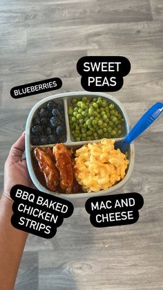 a person holding a bowl with different types of food in it, including macaroni and cheese