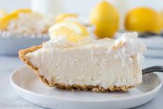 a slice of lemon cream pie on a plate with a fork in front of it