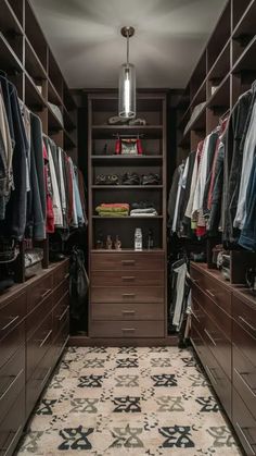 a walk - in closet with lots of clothes and shoes on the shelves, along with an area rug