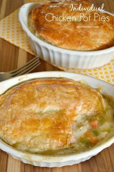 chicken pot pie in a white casserole dish on a wooden table with a fork