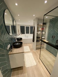 a modern bathroom with two sinks and a large mirror on the wall next to it