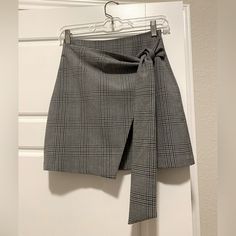 Grey Plaid Wrap Mini Skirt From Aritzia. Size Xs. Never Worn/Excellent Condition. Elegant High Waist Gray Skirt, Gray Mini Skirt For Work, Chic Gray Mini Skirt For Work, Elegant Gray Mini Skirt For Spring, Chic Gray Lined Skirt, Chic Gray Mini Skirt For Fall, Chic Gray Skort For Spring, Chic Gray Pleated Skirt, Chic High Waist Gray Mini Skirt