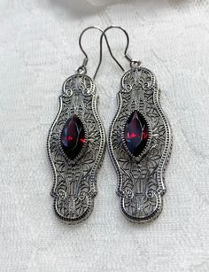 Red Garnet Cubic Zirconia Earrings Iris Design#E2 Custom Made Re-fashioned from an Art Deco pin from the 1920's, I now offer these lovely Antique reproduction earrings in sterling silver. Each stunning bezel set 2.78ct Red Garnet Cubic Zirconia gemstone is 14mm long by 7mm wide. The earrings are 2 1/2 inches long by 11/16th (17mm) wide. Notice the intricate design of the Art Deco filigree setting. A gift box is included and all items are shipped in the box for safe keeping. Feel free to ask ques Red Filigree Dangle Jewelry, Red Filigree Drop Earrings, Red Dangle Filigree Jewelry, Ornate Red Earrings For Party, Red Art Deco Jewelry For Formal Occasions, Ornate Red Filigree Earrings, Antique Red Earrings For Formal Occasions, Red Victorian Jewelry For Evening, Antique Red Dangle Jewelry