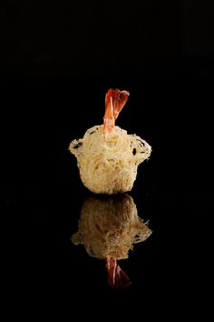 a piece of food sitting on top of a black surface