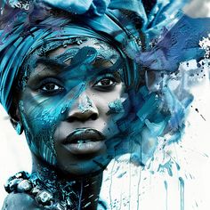 a woman's face is covered in blue paint and has butterflies on her head