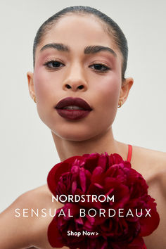 a woman holding a flower in her hand with the words nordstrom on it