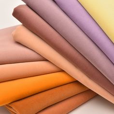 a stack of different colored sheets sitting on top of each other