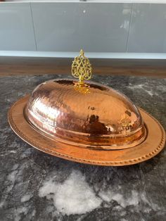 a golden platter on a marble counter top