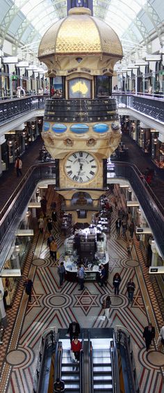 an overhead view of the inside of a shopping mall with escalators and stairs