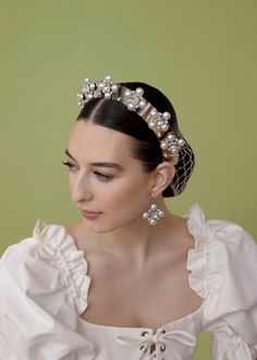 The Tudor Crown and its accompanying suite are the embodiment of classics re-imagined. Breathing life into the regality of design these stunning headbands have no comparison. Swarovski and pearl come together in perfect harmony in a way they were meant to. The Tudor Crown is as beautiful as it is comfortable and wearable and has the capability to elevate like no other headband can. Made in NYC.*The Tudor Crown in Silver is MADE TO ORDER and takes 2-3 weeks for shipment* Tudor Crown, Epona Valley, No Comparison, The Tudor, Perfect Harmony, Come Together, Gold And Silver, 3 Weeks, Silver Gold