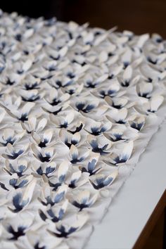 white and black paper flowers on top of a table