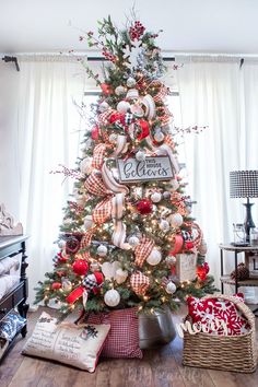 a christmas tree decorated with red, white and silver ornaments