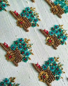 an embroidered fabric with blue and red flowers on it