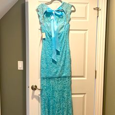 Long Gown Blue Lace Evening Dress For Homecoming, Blue Lace Dress For Homecoming, Floor-length Lace Dresses For Homecoming, Blue Lace Prom Gown, Light Blue Fitted Homecoming Gown, Blue Lace Sleeveless Gown, Sleeveless Blue Lace Gown, Blue Sleeveless Lace Gown, Light Blue Floor-length Evening Dress For Homecoming