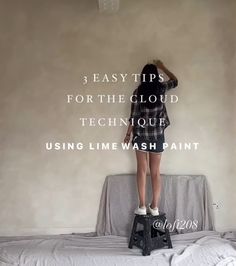 a woman standing on top of a step stool in front of a wall with the words 3 easy tips for the cloud technique using limewash paint