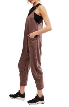 Keep it casual and relaxed in this slouchy jumpsuit designed in a baggy fit with handy pockets. 53" length; 23 1/2" inseam; 16 1/2" leg opening (size Medium) Pull-on style V-neck Racerback Back zip pocket; front patch pockets 95% cotton, 5% elastane Dry clean or machine wash, tumble dry Imported Slouchy Jumpsuit, Light Workout, Graphic Tee Style, Southern Women, Workout Days, Designer Jumpsuits, Hot Shots, Fp Movement, Oversized Silhouette