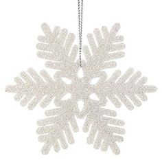 a white snowflake ornament hanging from a chain on a white background