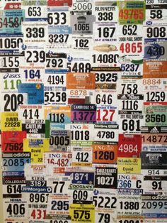 a large number of license plates hanging on a wall