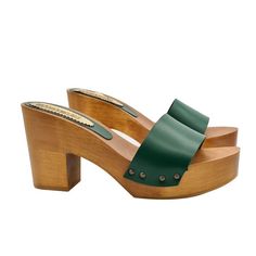 a pair of wooden shoes with green straps on the bottom and an open toed heel