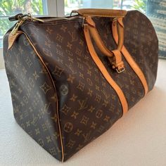 Authentic Louis Vuitton M41424 Keepall 55; Includes Original Lock And Keys In Box Good Used Condition. No Visible Rips Or Tears. Includes Lock And Key Current Msrp: $2,170.00 Date Code: Sd1004 (The Date Code Indicates A Production Date Of: October 2004 In France Or The United States (After 1995)) Condition: Monogram Canvas In Very Good Shape; No Rips Or Holes; Vibrant Monogram Print Color; Clean Interior And No Foul Odor; Zipper Works Perfectly; Excellent Hardwares; Beautiful Light Honey Patina Color Throughout Leather; Minimal Hairline Scratches And Stains On Leather Handle And Trims Minor Scratches On Leather Pipings; 8/10 Overall Condition Product Details From Website: The Keepall Pre-owned Brown Monogram Canvas Bag, Everyday Luxury Bags With Leather And Monogram Canvas, Luxury Everyday Monogram Canvas Bag With Leather Trim, Luxury Pre-owned Brown Bag, Pre-owned Designer Brown Bags, Designer Brown Coated Canvas Travel Bag, Designer Brown Travel Bag For Daily Use, Brown Designer Coated Canvas Travel Bag, Luxury Brown Travel Bag With Gold-tone Hardware