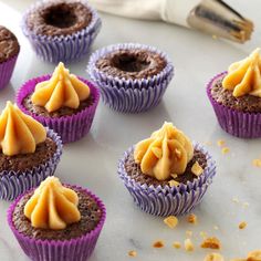 chocolate cupcakes with peanut butter frosting on top