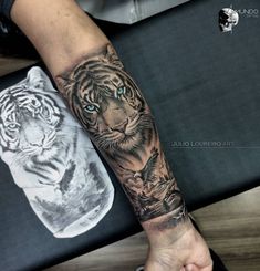 a person with a tiger tattoo on their arm