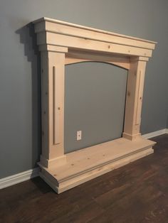 an empty fireplace in a room with blue walls and wood flooring on the ground