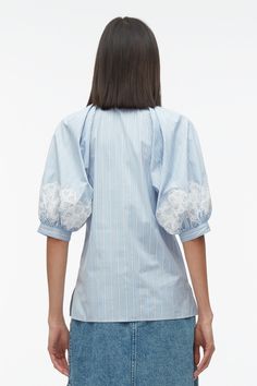 Striped poplin is interjected with lace detailing for a unexpected juxtaposition on this collared shirt. Pleated construction creates a sophisticated lantern sleeve that heightens the masculine and feminine play. Pair back with our denim paneled wrap skirt. 100% Cotton Short sleeve Long length Professional dry clean on Spring Cotton Tops With Contrast Lace, Puff Sleeve Tops With Lace Trim For Workwear, Sailor Shoes, Lace Oxfords, Knit Swimwear, Shirt With Lace, Oxford Blue, Stripe Shirt, Closet Designs