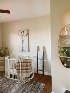 a baby crib in the corner of a room with a rug on the floor