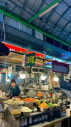 a food stand with lots of different types of foods on it's counter top