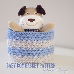 a stuffed dog in a blue and white crocheted basket with the words baby boy basket pattern on it